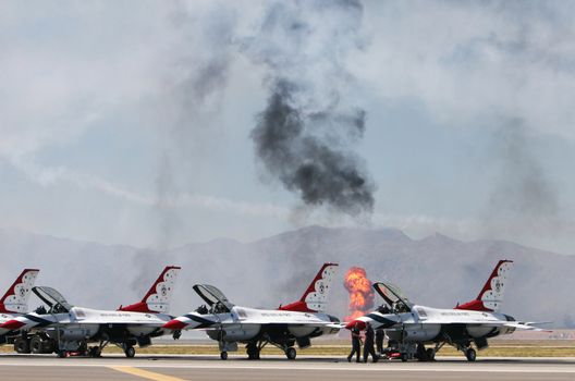 American pilots prepare their jets as explosions rock the background