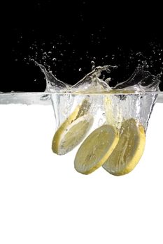 some lemon slices thrown in water with black and white background