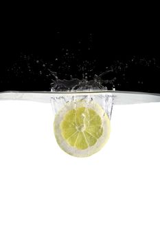 one slice of lemon thrown in water with black and white background