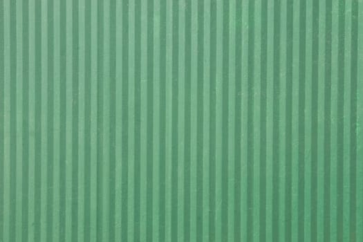 green surface of an old fence with vertical lines
