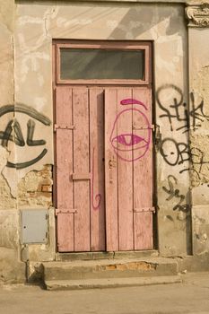 old wooden door with red and black graffiti 