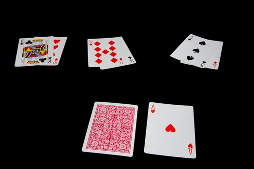 Three blackjack hands stand against the dealer's upturned ace against a black background
