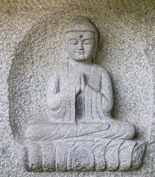 A Buddha carving in early morning light
