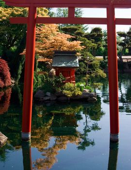 A Japanese pagoda scene is portrayed in a lake
