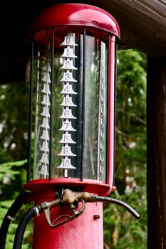 A shot of an old red gasoline pump
