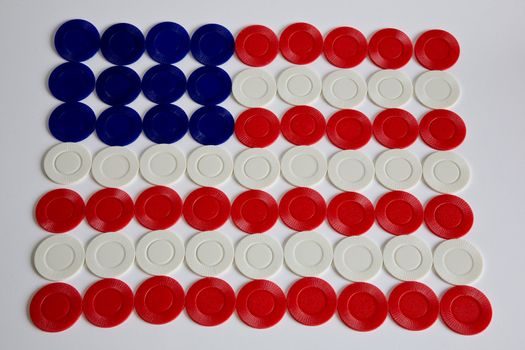 An American flag formed of poker chips over a white background
