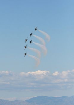 Six fighter jets flying in formation against a clear blue sky