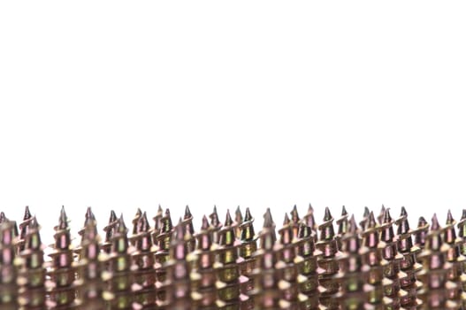 Close-up of golden screws as technology background