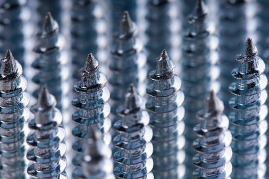 Close-up of silver screws as technology background