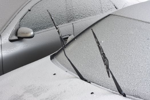 Two cars covered with snow