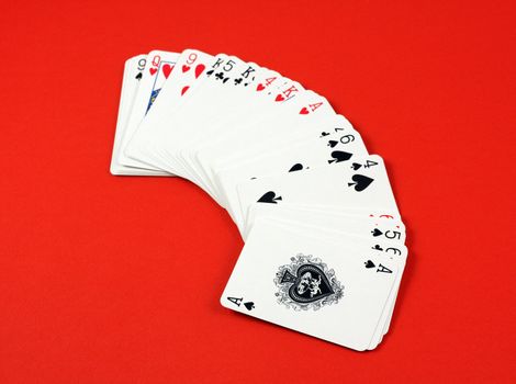 Playing cards on red deck