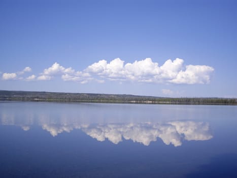 Clouds reflect on clear Yellowstone Lake USA