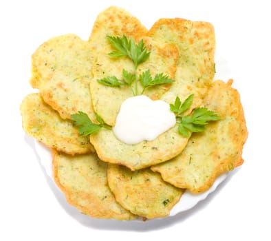 close-up pancake from marrow with parsley on plate view from above, isolated over white background