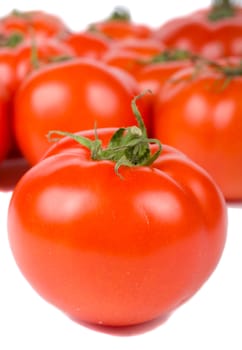 close-up ripe tomato on tomatoes background, isolated on white