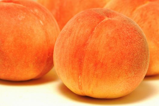 fresh detailed peaches background, focus on the front one