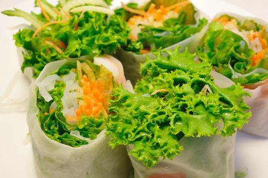 fresh and healthy green salad rolls close-up background; focus on the front salad leaf