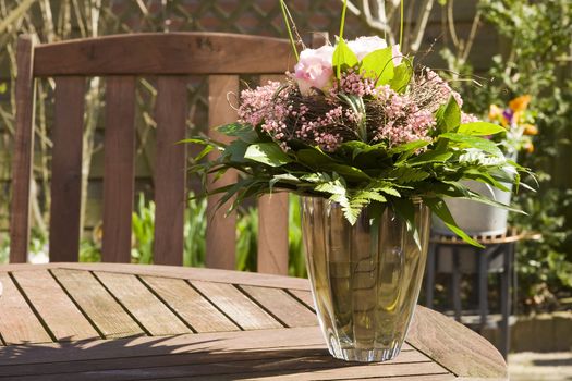 a bouquet in a vase in the garden