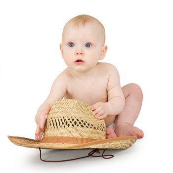 An infant with a straw cowboy hat on a white background