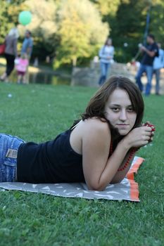 young woman resting near the pond