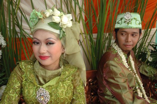 bride and groom wearing traditional costume from west java-indonesia