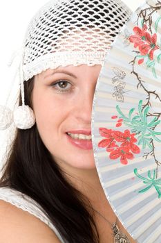 Temptress. Young woman with fan close up