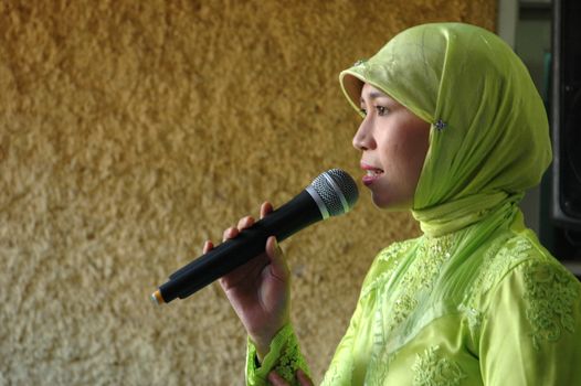 moslem lady get singing a song in a party
