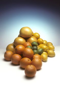 Pile of citrus fruit including oranges, lemons, limes and grapefruit