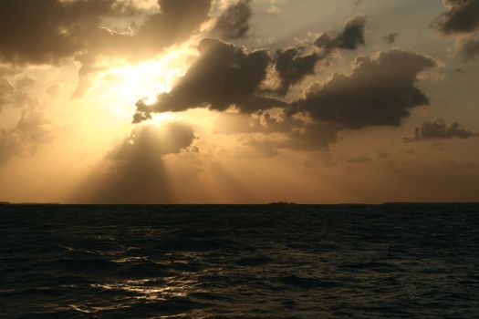 A dramatic sunset and the light and shadows from the clouds.