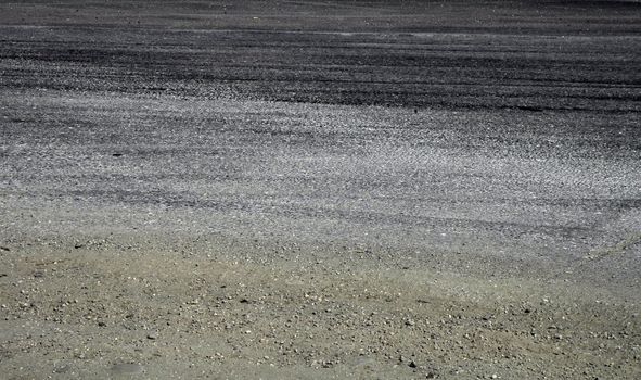 dirty asphalt rally road; tyres skids; gravel