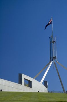 Australian Parliament House in Canberra, australian flag, clear blue sky