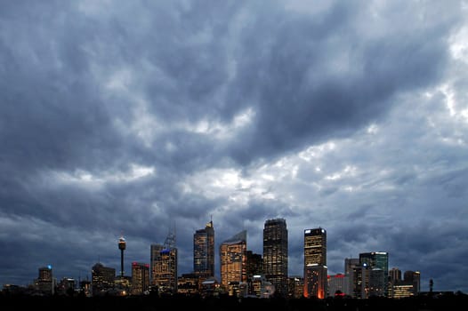 Dark clouds above sydney cbd, lights in buildings, night scene