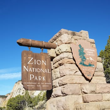 Wooden and stone sign for Zion National Park, Utah.