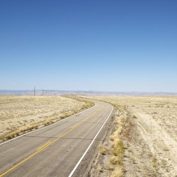 Road through barren landscape in Utah.