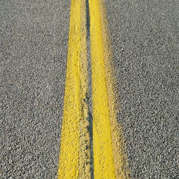 Close-up of double yellow lines in road.