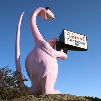 Pink dinosaur holding sign for city of Vernal, Utah.