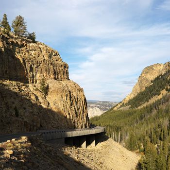 Highway winding through steep Wyoming mountains.