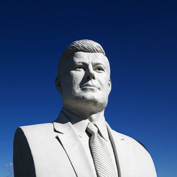 Bust of John F. Kennedy sculpture against blue sky in President's Park, Black Hills, South Dakota