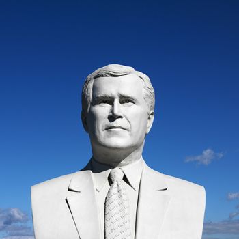 Bust of George Bush sculpture against blue sky in President's Park, Black Hills, South Dakota.