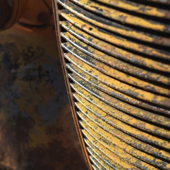 Close-up of radiator grill of rusty old pick-up truck.