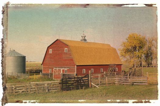 Red barn and fence in field.