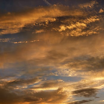 Golden clouds in sky with sunset.