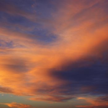 Orange clouds in sky with sunset.