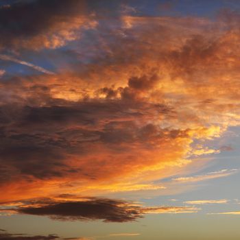 Orange clouds in sky with sunset.