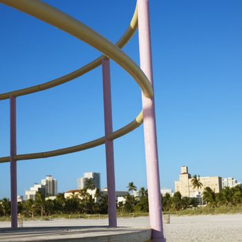 Pink and yellow painted railings of lifeguard tower on beach in Miami, Florida, USA.