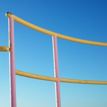 Pink and yellow painted railings of lifeguard tower on beach in Miami, Florida, USA.