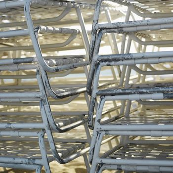 Close-up of stacked worn beach chairs in Miami, Florida, USA.