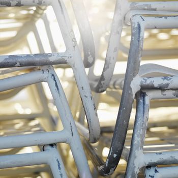 Close-up of stacked worn beach chairs in Miami, Florida, USA.