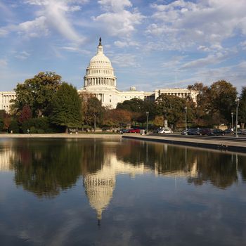 Capitol Building and reflection in water in Washington, DC, USA.