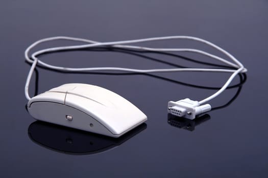 old computer mouse, serial port, dark reflective background