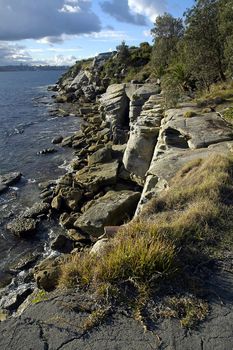 rocky coastline in Watson Bay, Sydney; Manly in backgound